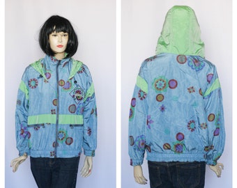 May include: A blue and green patterned jacket with a hood. The jacket has a zipper closure and a variety of colorful geometric shapes.