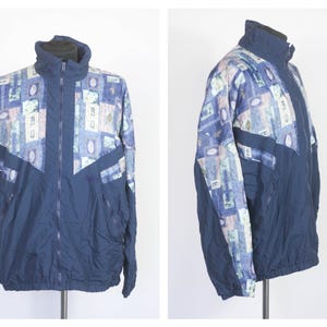 May include: A navy blue jacket with a colorful geometric pattern. The jacket has a zipper closure and a stand-up collar.