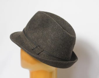 May include: A dark gray fedora hat with a black ribbon band.