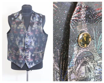 May include: A black vest with a silver and gold brocade fabric. The vest has a repeating pattern of fireworks and a clock face. The vest has a button closure.