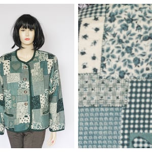 May include: A green patchwork jacket with a floral pattern. The jacket has a button closure and long sleeves.