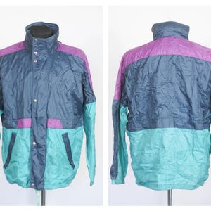 May include: A blue, teal, and purple color block windbreaker jacket with a zipper closure and snap buttons.