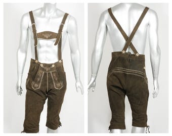 May include: Brown leather lederhosen with suspenders. The traditional Bavarian shorts feature decorative stitching and button details. The suspenders are attached to the shorts with buttons and have adjustable buckles.