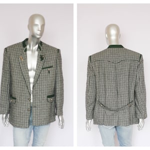 May include: A black and white checked blazer with green trim. The blazer has a single button fastening and two pockets on the front.
