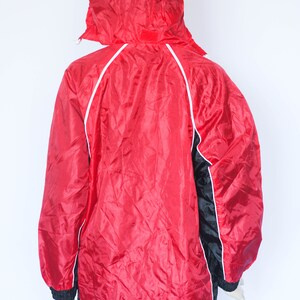 May include: Red and black hooded jacket with white piping. The jacket has a zipper closure and a drawstring hood.