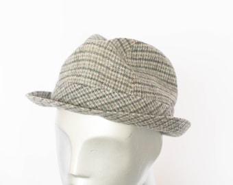 May include: A gray and brown plaid fedora hat.
