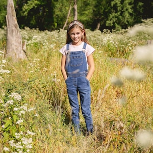 A girl wearing floral headband in outdoor setting