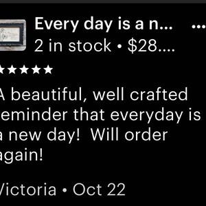 May include: A black and white framed print with the text "Every day is a new day!"  The print is on a black background with white text. The frame is made of wood and has a distressed finish. The print is 2 inches in stock and costs $28.