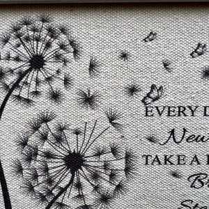 May include: Black and white illustration of two dandelion seeds with butterflies flying away. The text "EVERY DAY IS A NEW DAY, TAKE A DEEP BREATH, START AGAIN" is printed below the dandelions.