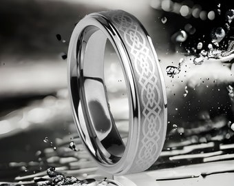 May include: A silver tungsten carbide ring with a Celtic knot design etched into the band.