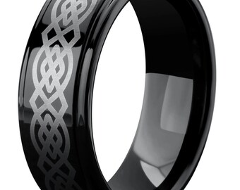 May include: A black tungsten carbide ring with a silver Celtic knot design engraved on the band.