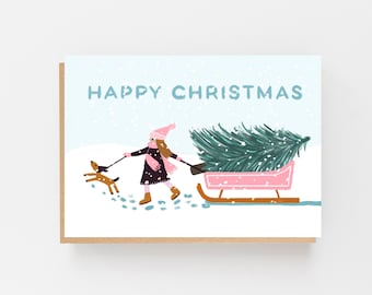 Happy Christmas Card - Girl pulling a sledge with a Christmas tree and her dog - Christmas Card