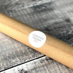 May include: A brown paper tube with a white circular label that says "LOMOND PAPER CO."
