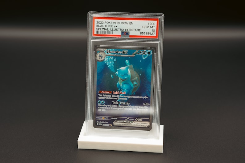 May include: A graded Pokemon trading card in a protective case. The card is a Blastoise ex Special Illustration Rare from the 2023 Pokemon Mew EN set. The card is graded GEM MT 10 and has a PSA number of 85735427.
