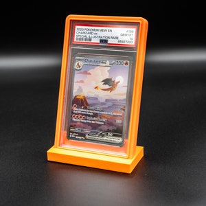 May include: A graded Pokemon card in a protective case. The card is a special illustration rare Charizard from the 2023 Pokemon Mew set. The card is graded a GEM MT 10 by PSA, with a number of 85027293.