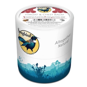 May include: A white cylindrical container with a blue and green nature scene at the bottom. The top of the container has a red and white label with the text "Songbird Throat & Chest Balm" and a list of ingredients. The label also includes the text "Altogether Natural".