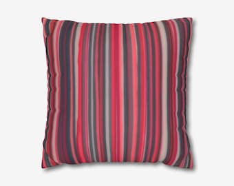 May include: A red and gray striped throw pillow with a soft, textured fabric.