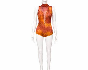 May include: A sleeveless bodysuit featuring a high mock neck and a deep, plunging V-shaped cutout along the chest. The garment displays a mottled, tie-dye pattern in shades of burnt orange, deep red, and yellow, with small beads lining the cutout.