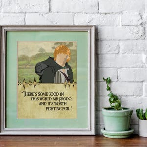 May include: A framed print with a quote from the Lord of the Rings. The quote reads "There's some good in this world Mr Frodo, and it's worth fighting for..." The print features a cartoon illustration of a red-haired character with a green background.