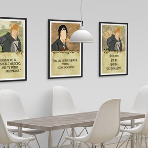 May include: Three framed prints with illustrations of characters from the Lord of the Rings. The prints feature quotes from the characters. The prints are hanging on a white wall above a wooden table with white chairs.