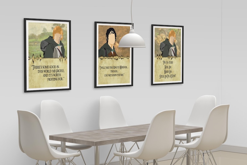 May include: Three framed prints with illustrations of characters from the Lord of the Rings. The prints feature quotes from the characters. The prints are hanging on a white wall above a wooden table with white chairs.