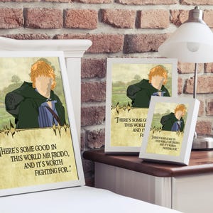 May include: A white framed print with a quote from the Lord of the Rings movie. The quote reads "There's some good in this world Mr. Frodo, and it's worth fighting for..." The print features a cartoon illustration of Frodo Baggins, a character from the Lord of the Rings.