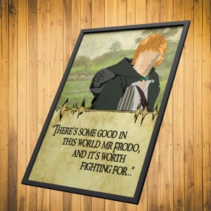 May include: A framed print featuring a cartoon illustration of a character from the Lord of the Rings, with a quote from the book: "There's some good in this world Mr Frodo, and it's worth fighting for..."