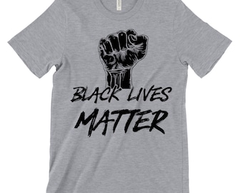 May include: A gray t-shirt with a black fist raised in the air and the text "Black Lives Matter" in black.