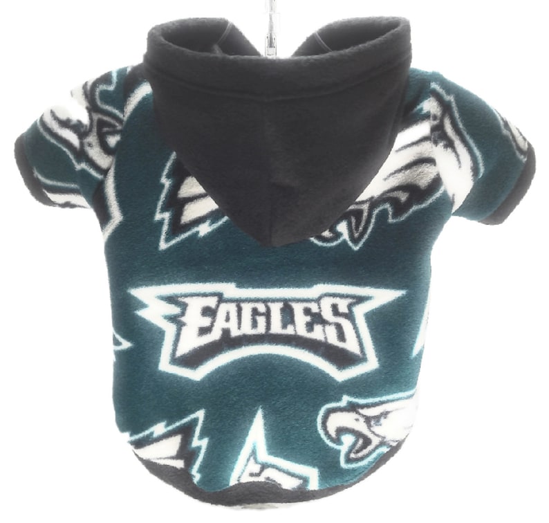 May include: Green and white fleece dog hoodie with the Philadelphia Eagles logo and the word "EAGLES" repeated on the fabric. The hoodie has a black hood.