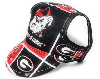 May include: Black and red dog hat with the University of Georgia logo and a bulldog mascot. The hat has a red and white checkered pattern with the University of Georgia logo and the bulldog mascot.