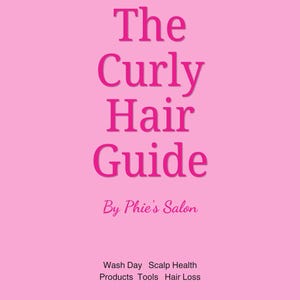May include: A pink cover for "The Curly Hair Guide" by Phie's Salon. The title is in large, bold, pink letters. Below the title is the salon's name in a smaller, cursive, pink font. The cover also lists topics like wash day and hair loss.