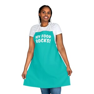 May include: A turquoise apron with white text that reads "My Food Rocks!"