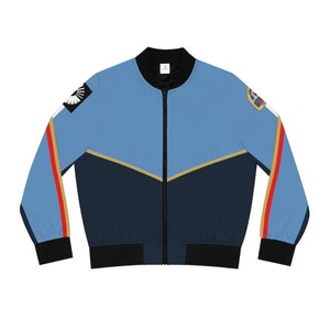 May include: A blue, navy blue, and gold bomber jacket with red accents. The jacket has a zipper closure and two pockets. The jacket has a patch on the right sleeve with the text "Space Force" and a patch on the left sleeve with a white star.