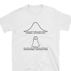 May include: White t-shirt featuring a black graphic of a bell curve labeled "Normal Distribution" above a ghost figure with the label "Paranormal Distribution". The shirt is a short-sleeved crew neck.