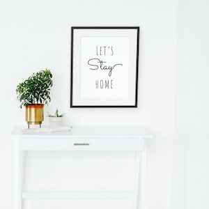 Let's Stay Home framed in a hallway and entry