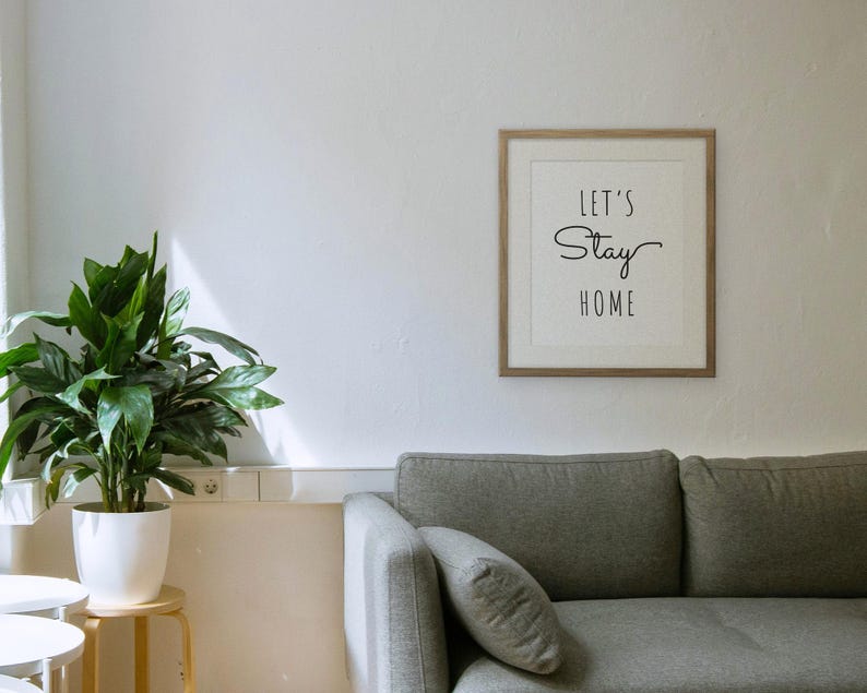 Let's Stay Home framed in a living room