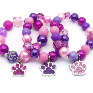 Paw bracelets party favors in organza bags with special birthday girl bracelet!