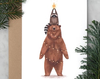 Tarjeta navideña de felices fiestas de oso y mapache