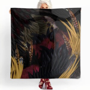 May include: A black silk scarf with a colorful feather pattern. The feathers are in shades of gold, red, and black. The scarf is draped over a person's shoulders.