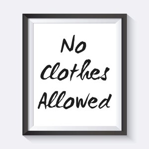 May include: A black framed sign with white background and the text "No clothes allowed" written in black.