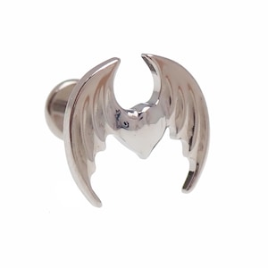 May include: A silver-coloured earring with a bat wing design. The earring has a small, round post and a detailed wing shape with curved edges. The wings are spread out, creating a symmetrical design.