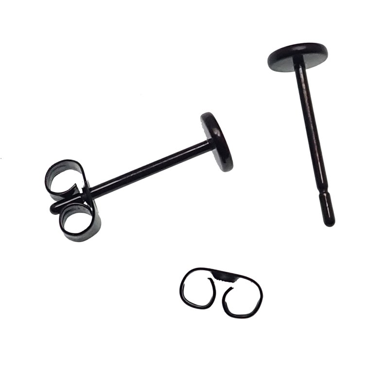 May include: A pair of black stud earrings with a butterfly back closure. The earrings are made of stainless steel and are hypoallergenic.