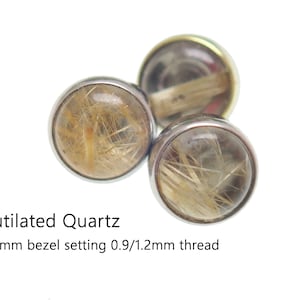 May include: Three silver bezel settings with rutilated quartz stones. The stones are clear with gold inclusions. The bezel settings are 4mm and have a 0.9/1.2mm thread. Rutilated Quartz.
