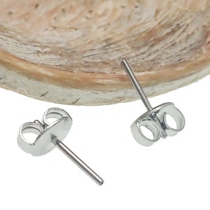 May include: Two silver earring posts with a butterfly back. The posts are made of metal and have a smooth finish.