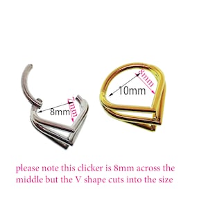 May include: Two clicker rings, one silver and one gold, with a V-shaped design. The silver ring is 8mm across the middle and the gold ring is 10mm across the middle. "Please note this clicker is 8mm across the middle but the V shape cuts into the size"