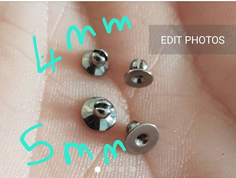 May include: Four small, metallic, silver-colored studs with flat circular bases and rounded tops. Two studs are labeled 4mm and two are labeled 5mm in light blue text. The studs have a reflective finish and a small slit on the top of each rounded head.