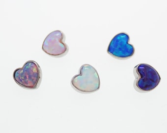 May include: Five heart-shaped opal stones in shades of pink, blue, and white. Each stone is set in a silver bezel. The opals have a shimmering, iridescent quality, with flashes of color.