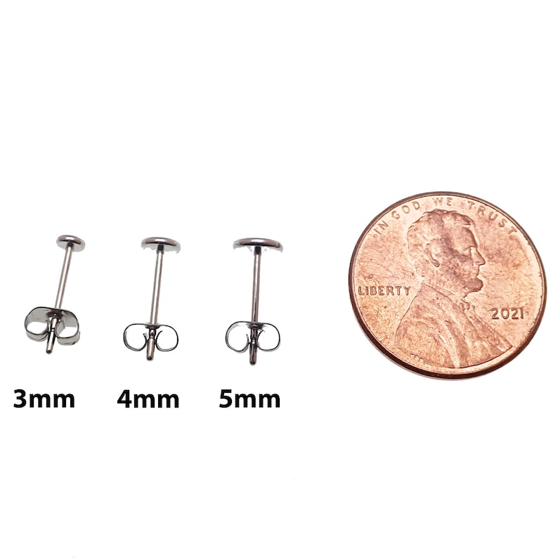 May include: Three stainless steel earring posts in sizes 3mm, 4mm, and 5mm. The earrings are shown next to a US penny for size comparison.