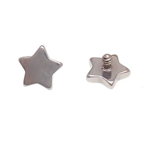 May include: Two silver-toned star-shaped jewelry components. One piece shows the smooth, flat front surface, while the other displays the back with a small, threaded metal post extending from the center for attachment purposes.