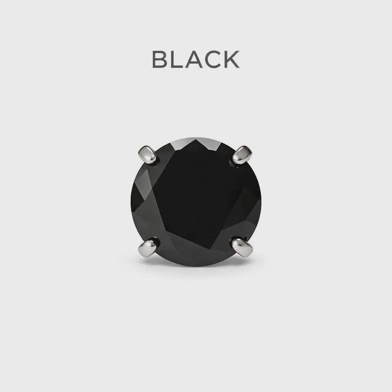 May include: A single black gemstone stud earring with a round, faceted design. The earring is held in place by four silver prongs. The word "BLACK" is printed above the earring.